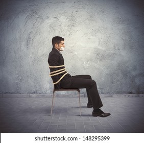 businessman-trapped-chair-rope-260nw-148295399.jpg