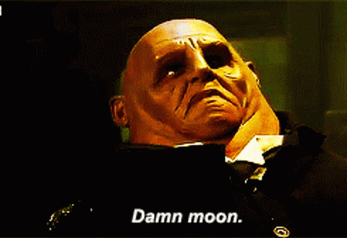 Strax, a Sontaran wearing human clothing, looking toward the sky and saying Damn moon.