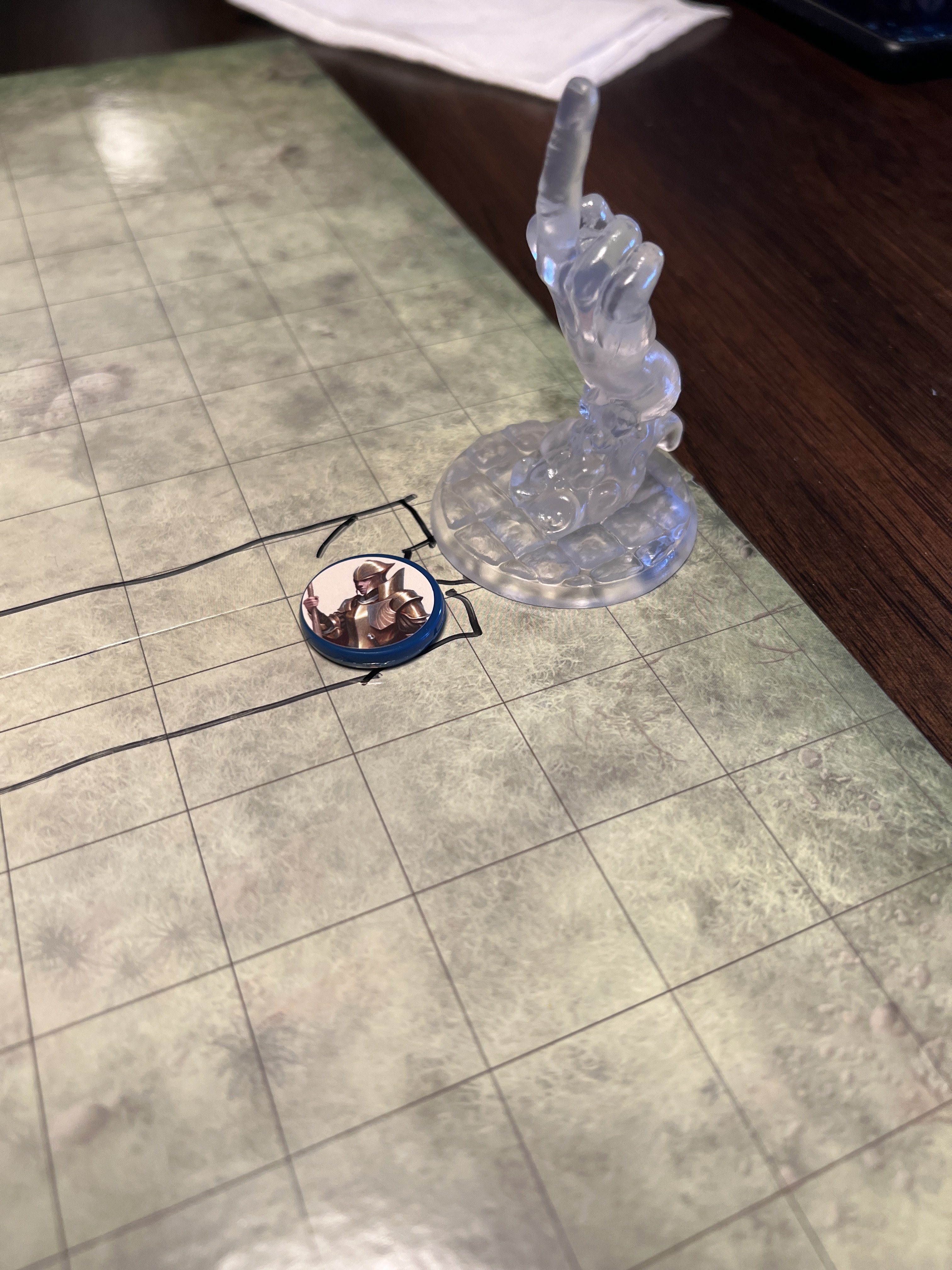 A large clear miniature of a hand, Bigby's magic middle finger.