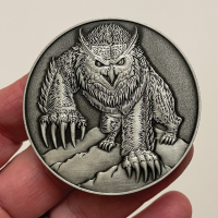 Front-of-Owlbear-Goliath-Coin-in-hand.png
